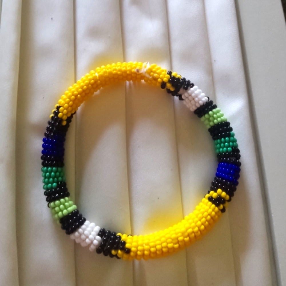 African bracelet. Made from beads and chewed leather which makes it flexible.
